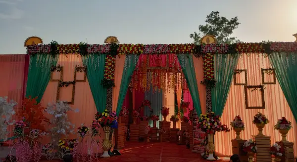 Outdoor wedding stage with floral backdrop at dusk