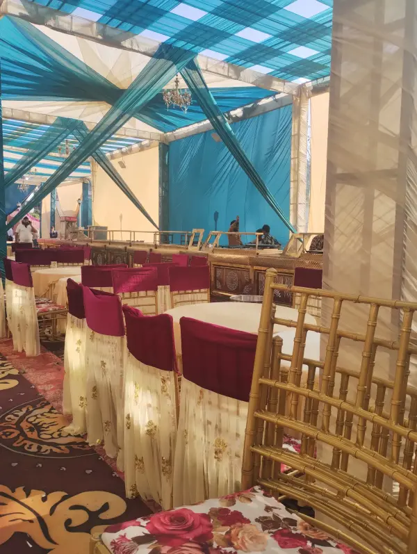 Banquet seating with teal drapes and floral table settings