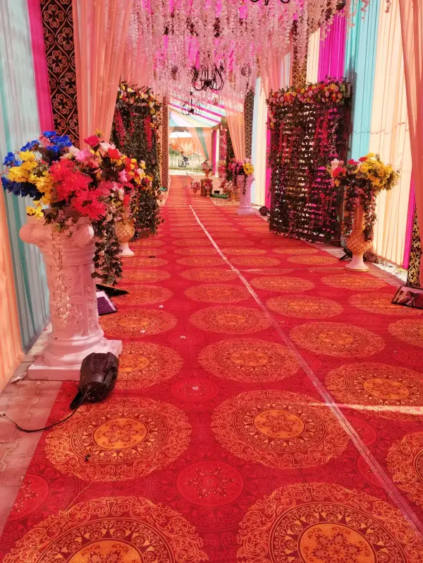 Walkway with flower pillars and red patterned carpet