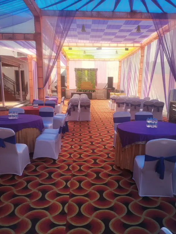 Banquet setup with purple drapes and round tables